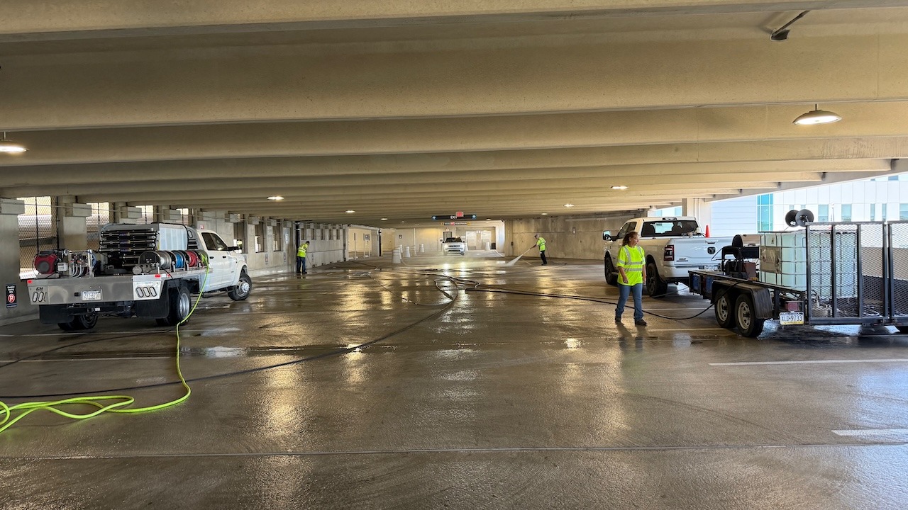 ASM Environmental crew pressure washing a commercial parking garage using truck-mounted cleaning equipment in Wilkes-Barre, Pennsylvania.